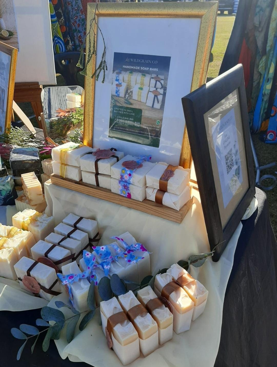 Two sisters wrapping a bar of artisan tallow soap